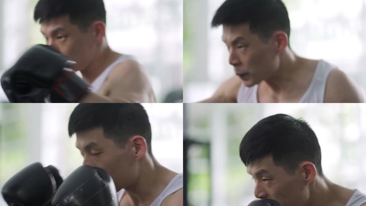 亚洲中国人在健身房练习沙袋