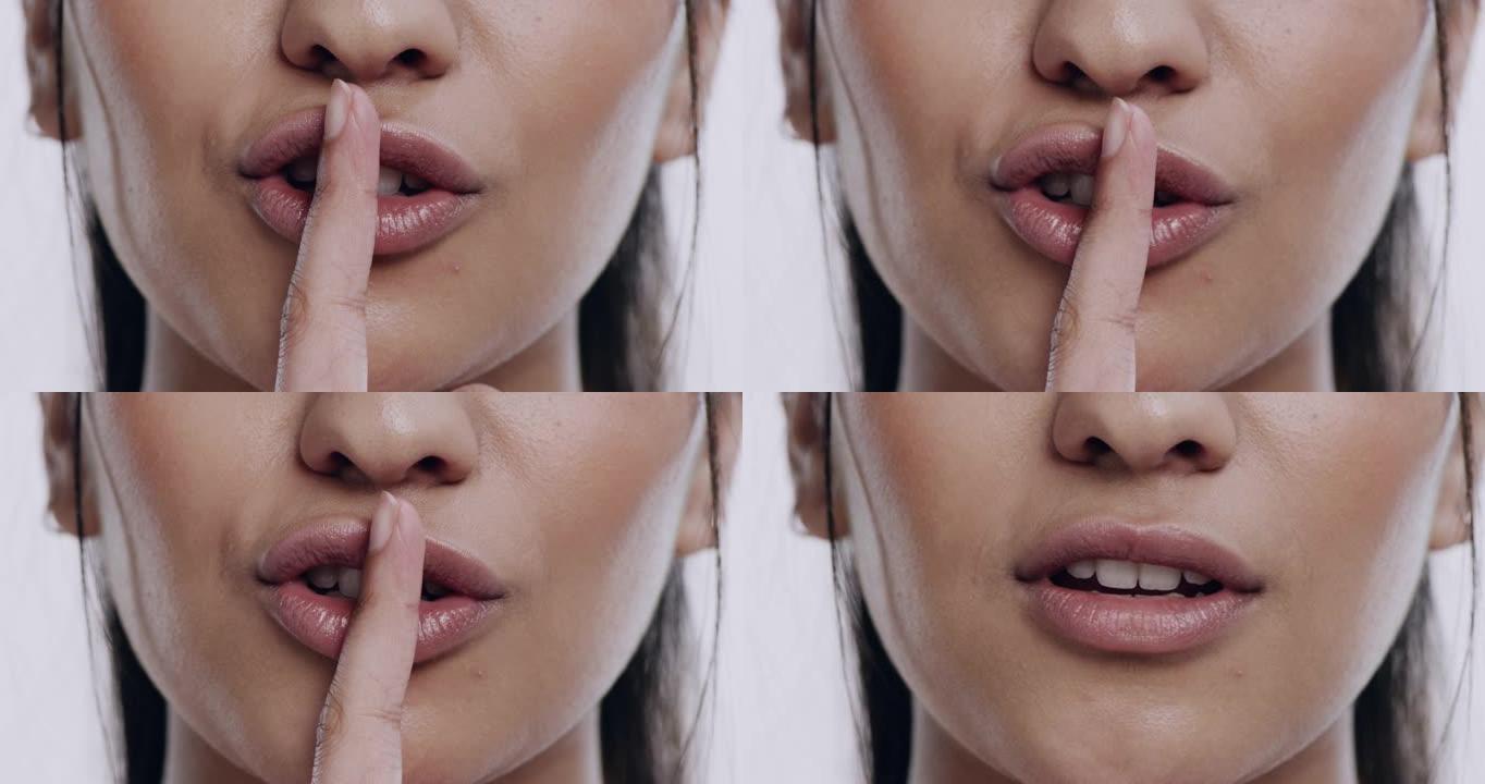 4k视频片段，一个无法辨认的女人独自站在工作室里，用手指指着嘴唇