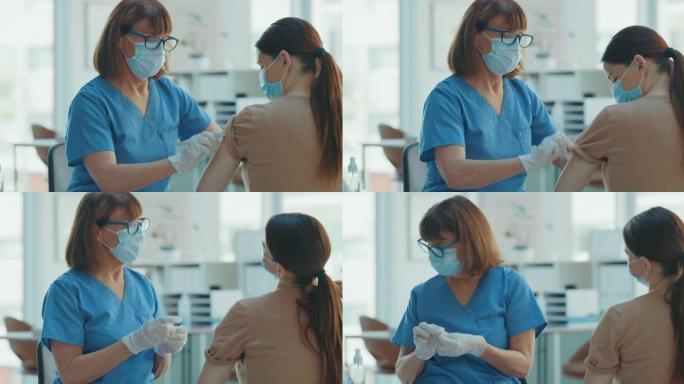 4k视频片段，一名护士在给她的病人注射了Covid疫苗后给她贴了创可贴
