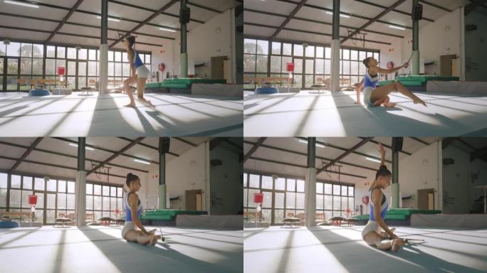 体操运动员，俱乐部做体操表演和艺术体操训练。年轻女子在健身房做例行舞蹈，使用球杆或棍棒。奥运会比赛的