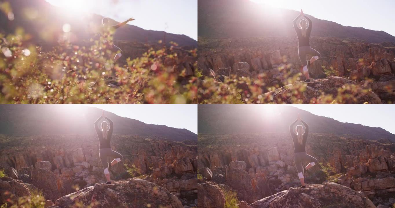 4k视频录像一名年轻女子在山上做瑜伽