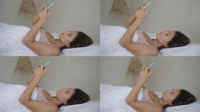 无聊的女人在床上用电话