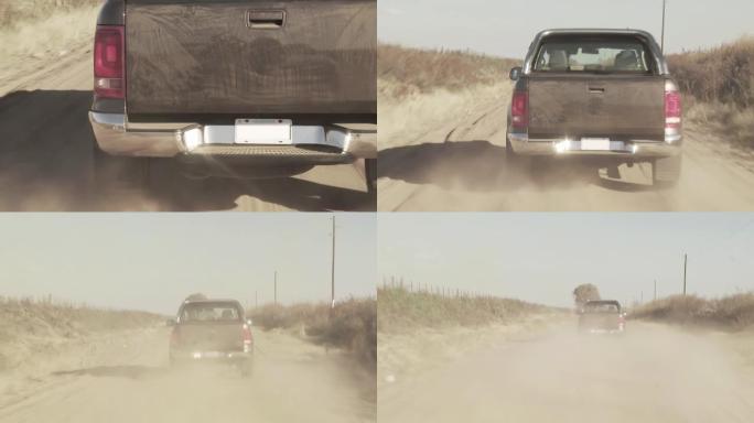 皮卡车在阿根廷尘土飞扬的乡村道路上加速行驶。4k分辨率。