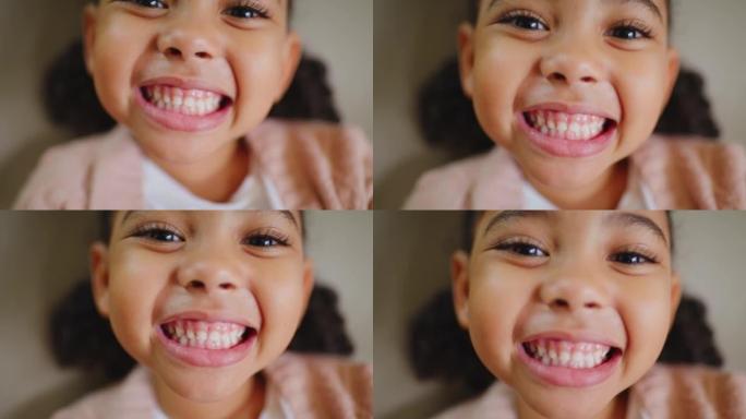 顽皮的小孩为正畸医生微笑，并对她的口腔卫生牙科预约充满信心。一个可爱的小女孩在牙医检查时露出牙齿的特