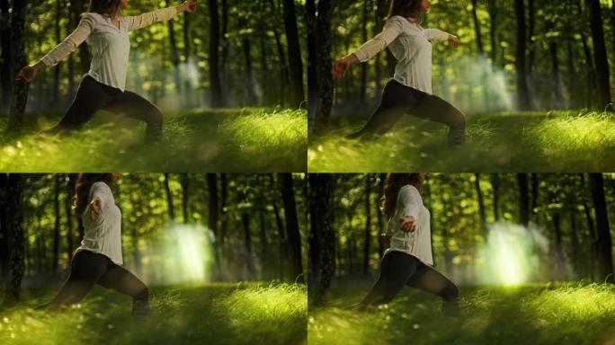 SLO MO年轻女子在朦胧的绿色森林中练习瑜伽