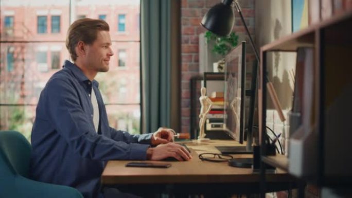 年轻英俊的男人坐在家里，用设计软件在台式电脑上工作。创意男性查看社交媒体，浏览互联网。明亮阁楼公寓的