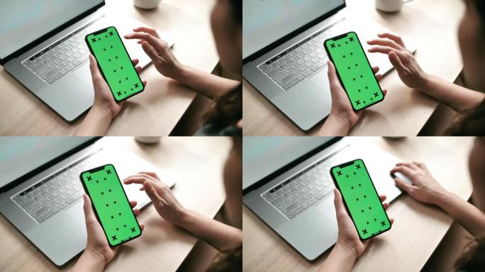 女人使用绿屏智能手机触摸屏