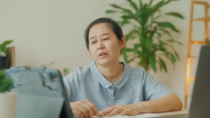 亚洲高级女性在家工作时克服问题。