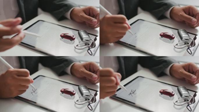 商人在平板电脑上签署数字合同签名，购买汽车