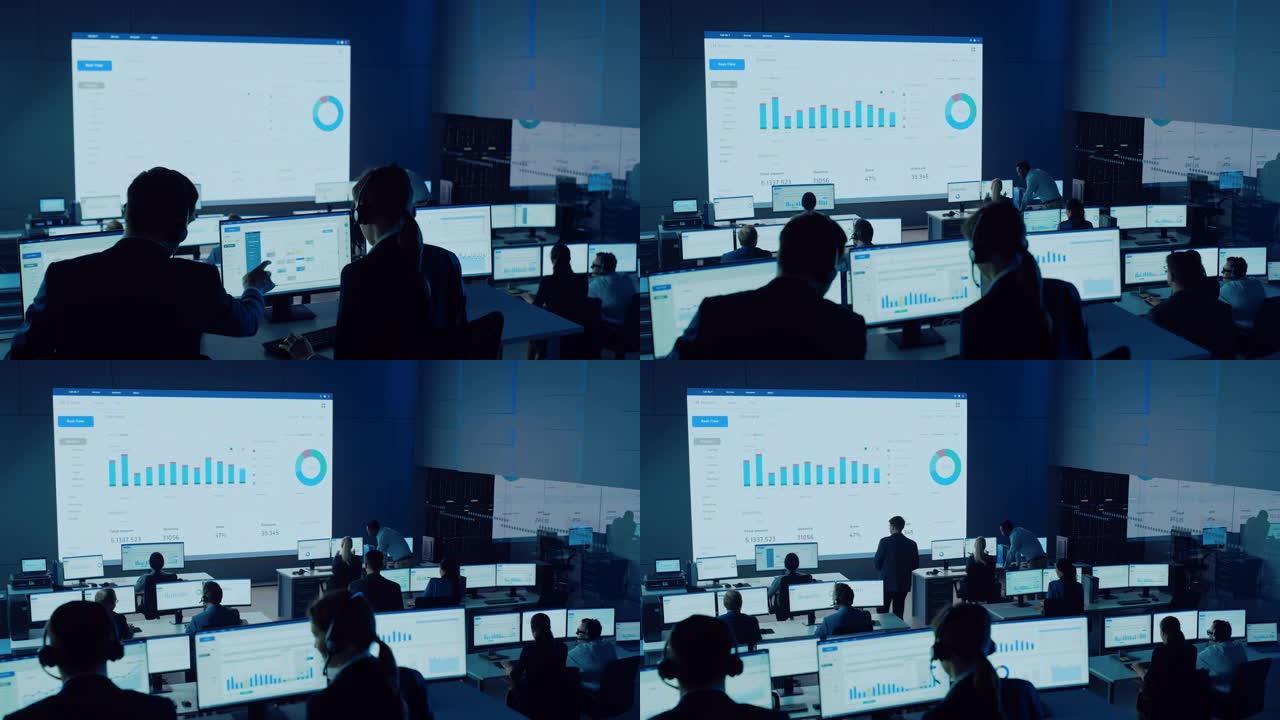 专业交易员在现代监控办公室工作，在大屏幕上提供实时分析供稿。经纪人和金融专家的监控室坐在电脑前。