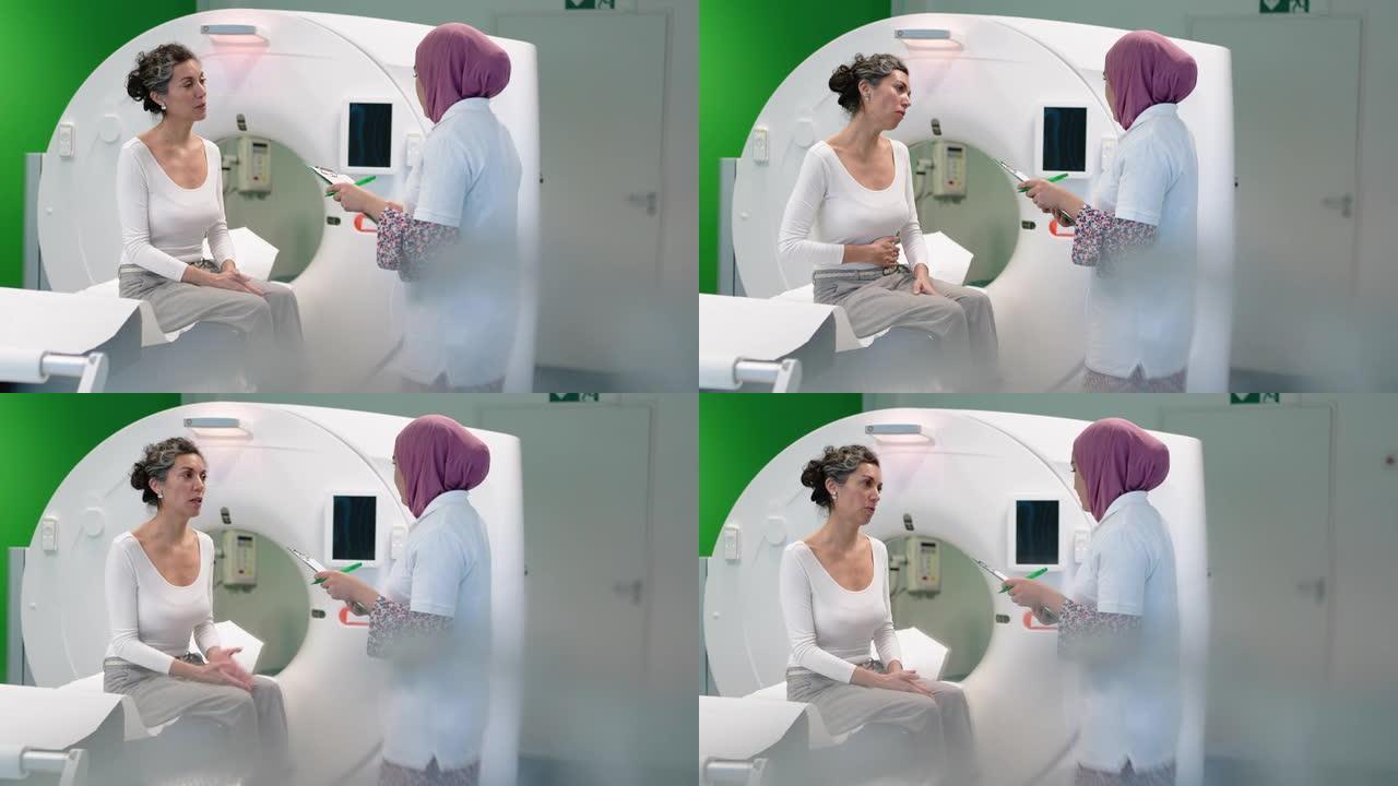 女性护士在CAT扫描前与女性患者交谈