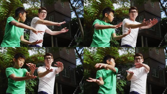 快乐的亚洲人和sonr一起在花园里锻炼，一起练习太极拳