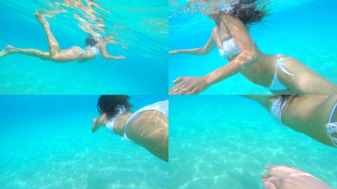 4k视频片段，一名无法识别的妇女在意大利度假期间在海洋中游泳