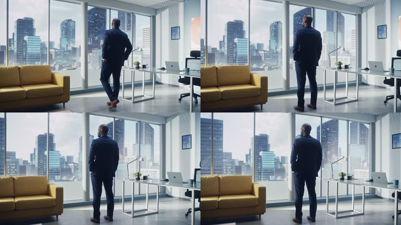体贴的非洲裔美国商人穿着一件完美的西装，站在他的办公室里，看着窗外的大城市。成功的CEO规划电子商务