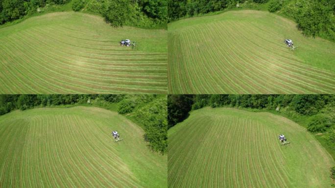 使用干草tedder在新修剪的牧场上进行空中拖拉机，以更快地干燥草