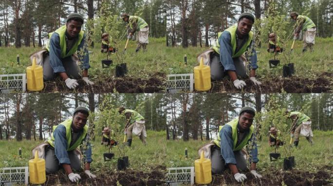 树苗摆姿势的黑人工人形象笑脸环境治理种树