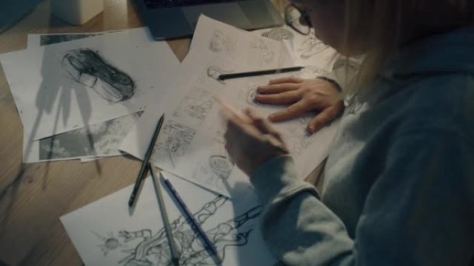 女性创意设计师在故事板上工作，并为她的项目绘制草图