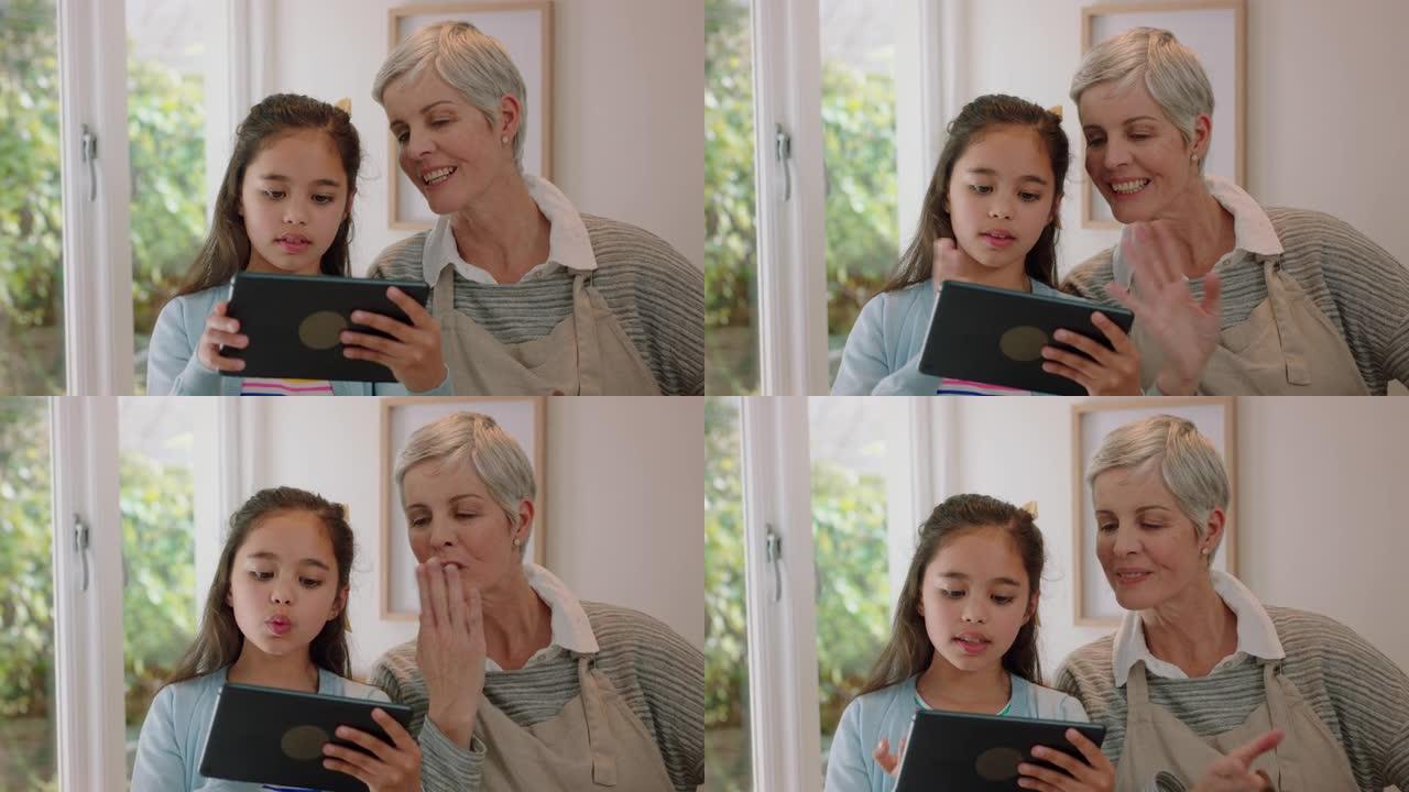 祖母和孩子使用平板电脑进行视频聊天小女孩与奶奶分享假期周末与孙女在家享受移动技术聊天