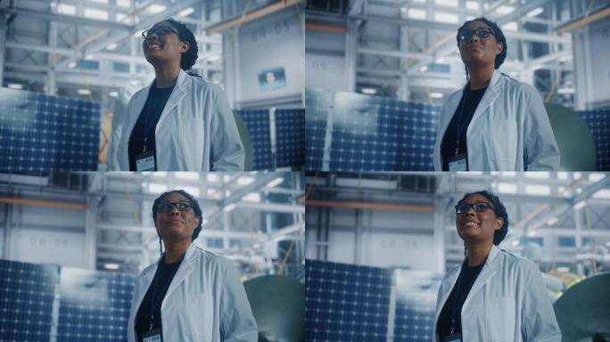 才华横溢的女工程师在航空航天卫星制造工厂四处张望。年轻人才开始了她在世界顶级科学技术太空探索计划中的