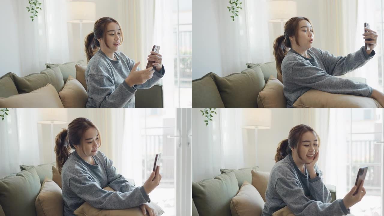 年轻女子在家中通过智能手机进行视频通话