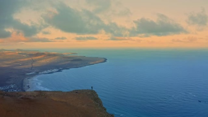 西班牙加那利群岛日落时站在悬崖边缘的空中WS人