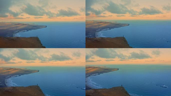 西班牙加那利群岛日落时站在悬崖边缘的空中WS人