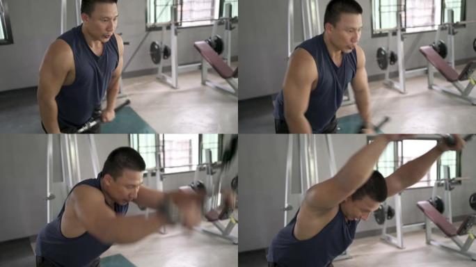 在健身房锻炼肌肉的亚洲男子