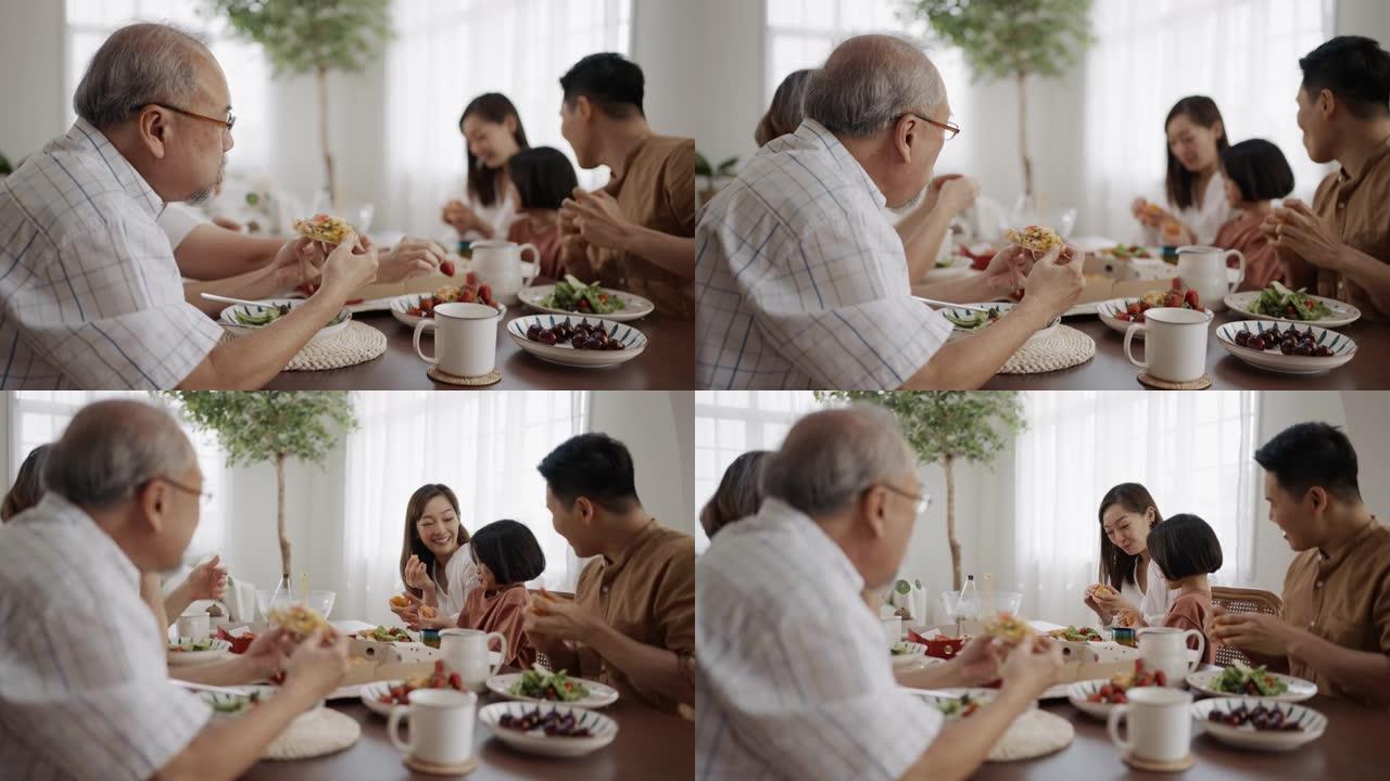 快乐的亚洲家庭在家里的餐桌上一起享用午餐