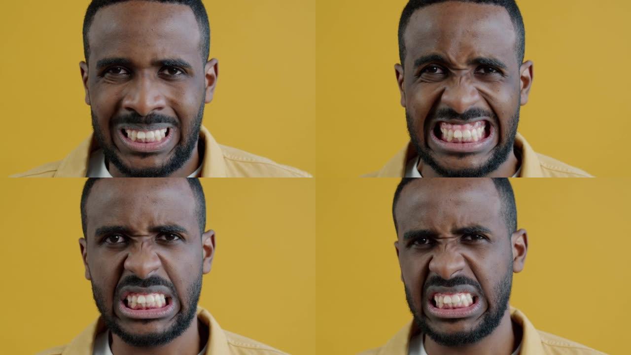 愤怒的表情看着相机的疯狂非裔美国人的特写肖像