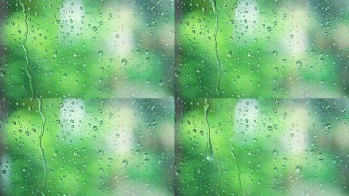 绿色自然背景玻璃上的雨滴