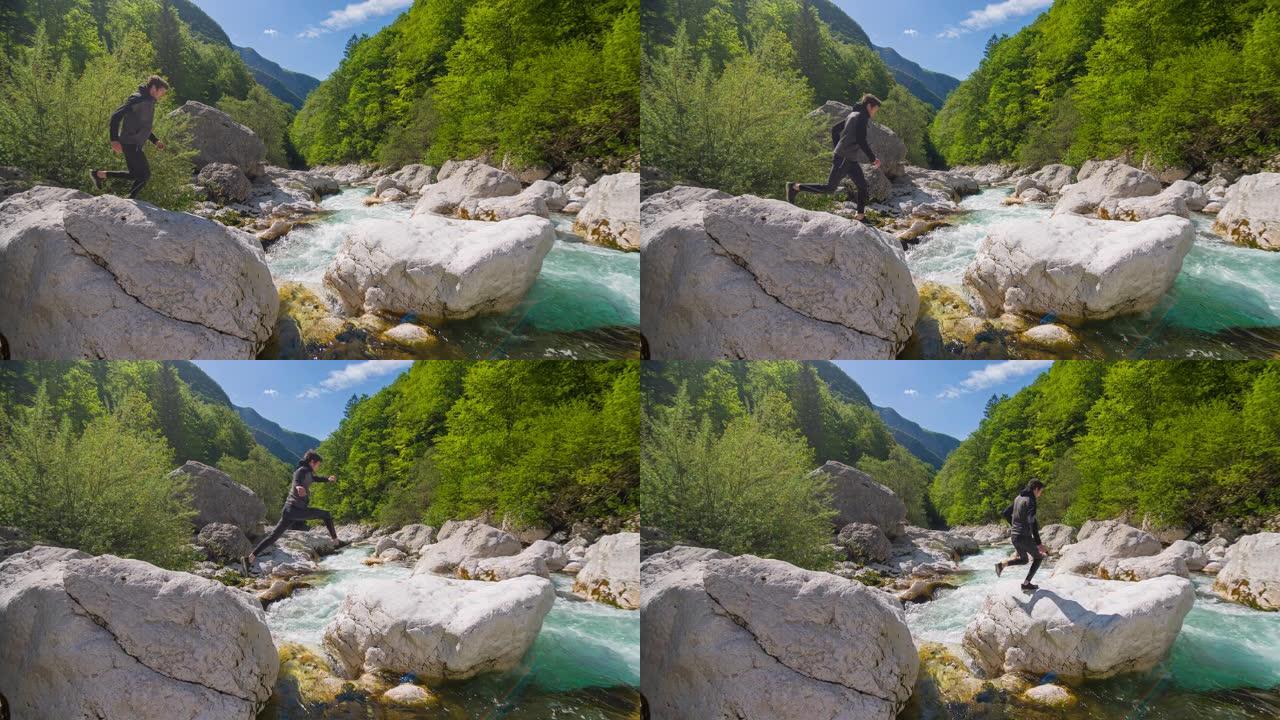 年轻人在雄伟的风景中跳过山河