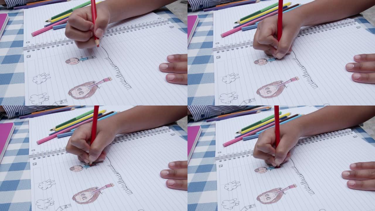 无法辨认的女孩在笔记本上画画的特写