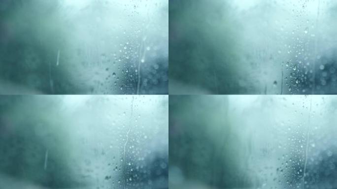 蓝色绿松石背景玻璃上的雨滴