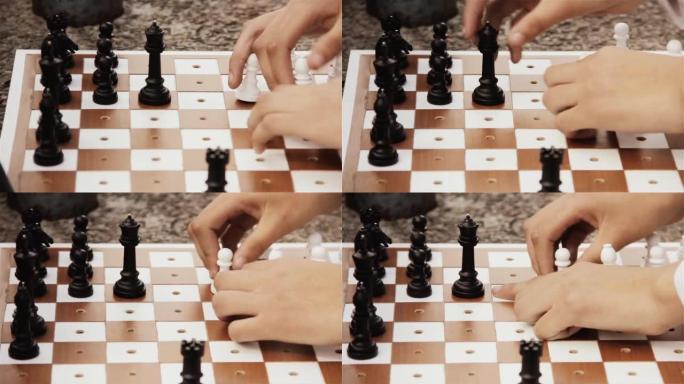 盲人或视障学校男生的手在户外为盲人或视障人士下棋。特写。
