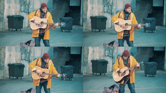 一个无家可归的人在街上弹吉他