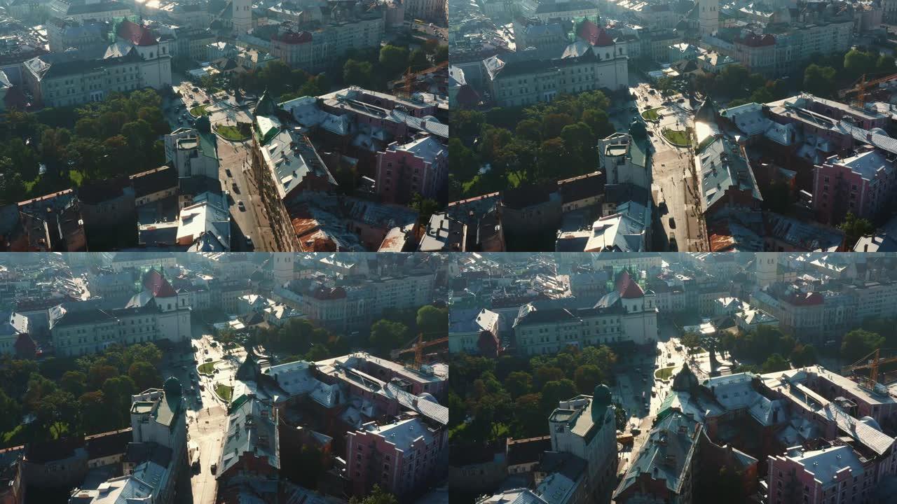 在和平的夏季日出时，在乌克兰老利沃夫市中心的田园诗般的历史建筑，街道和广场的空中拍摄。