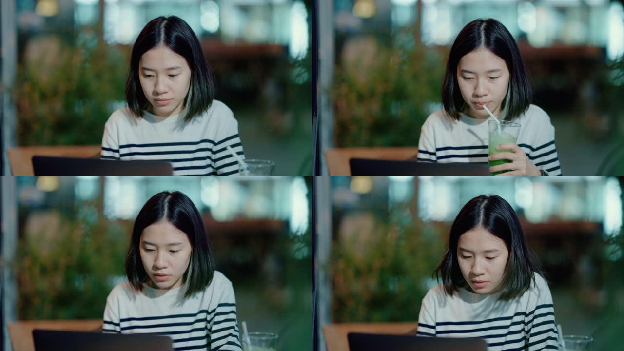 年轻女子在笔记本电脑上与朋友在线交流。