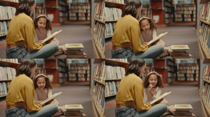 两个女人只坐在图书馆的地板上一起看书。可爱的女儿和图书馆的母亲。