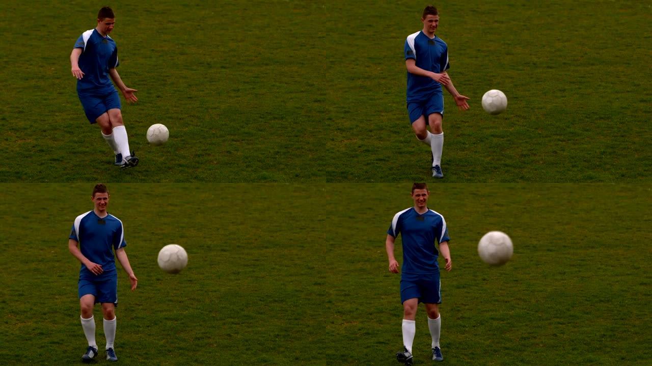 蓝色足球运动员在球场上踢球