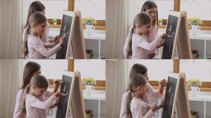 慈爱的母亲和小女儿用粉笔在船上画画