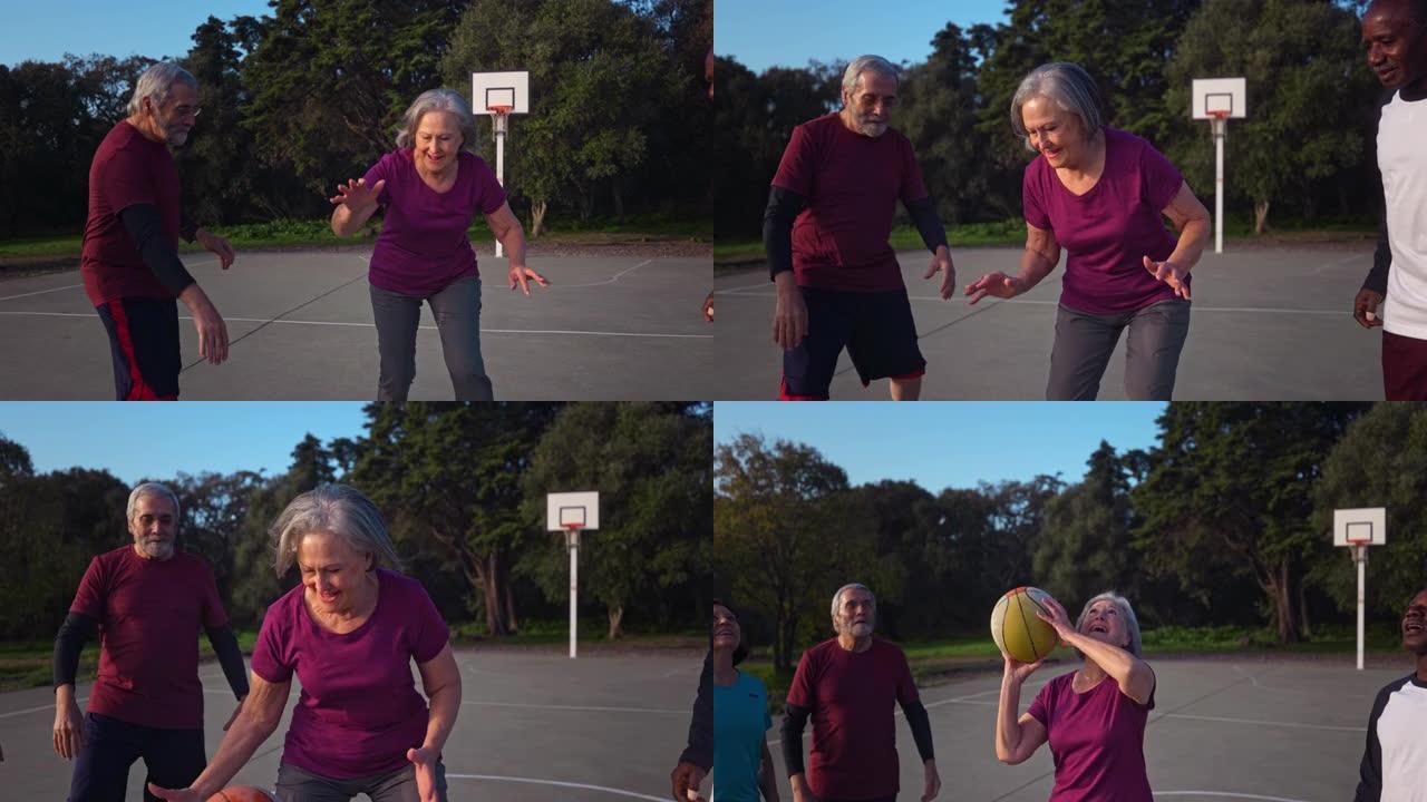 高级女子与一群老年人户外球场一起运球篮球