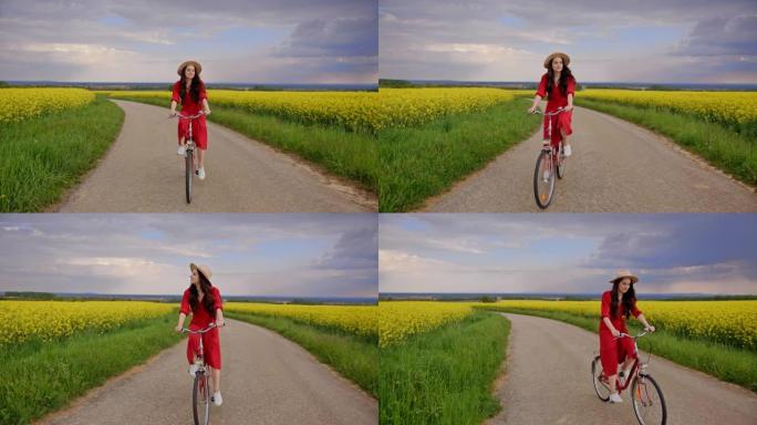追踪一名黑发女性骑自行车穿过充满活力的黄色金鱼草花朵的照片，穿着红色连衣裙和米色帽子