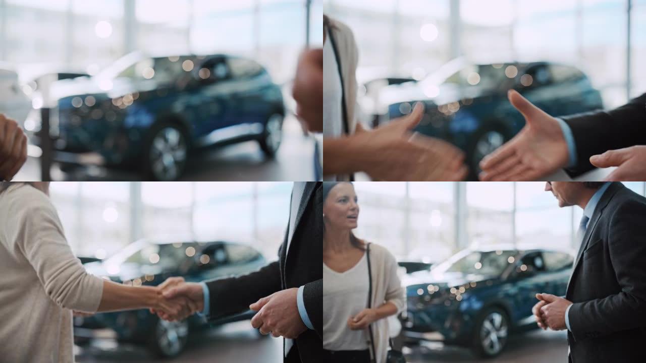 SLO MO汽车推销员握手并将新车钥匙交给女顾客