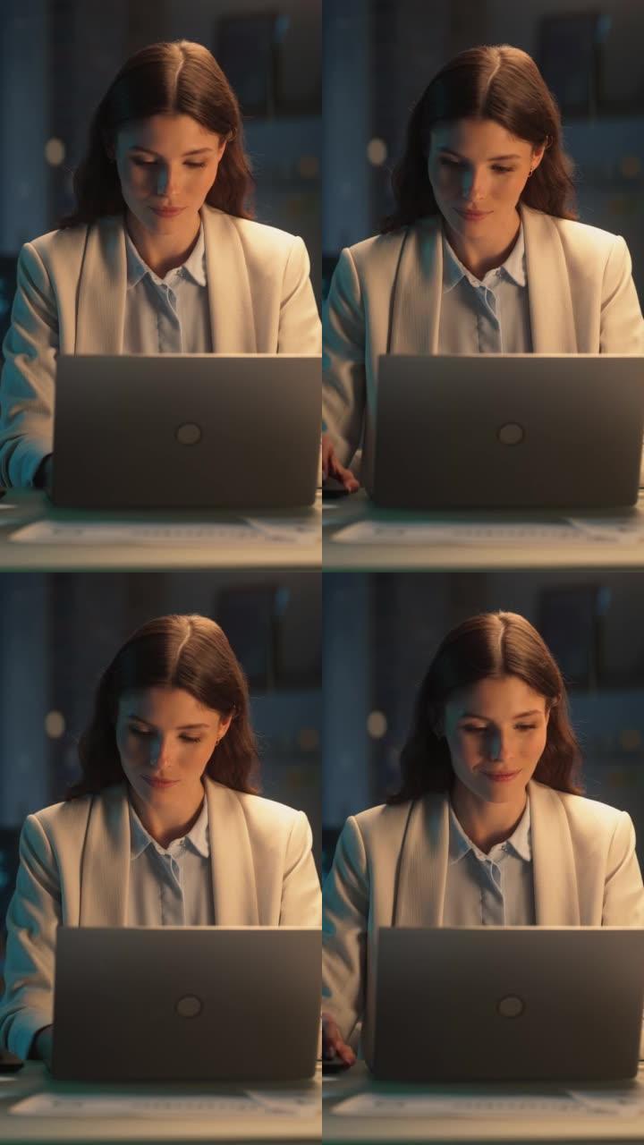 垂直屏幕: 晚上在公司办公室工作的女性在笔记本电脑上工作。年轻的经理浏览互联网，在线购物并阅读朋友和