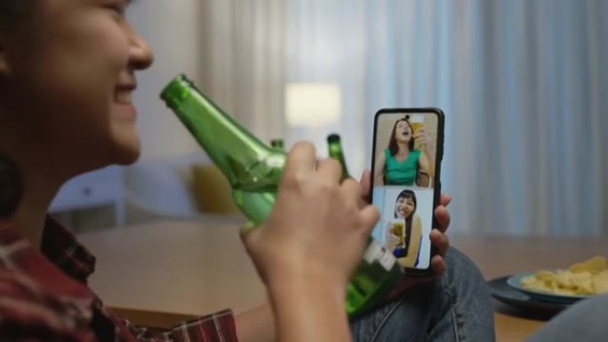 年轻快乐迷人的亚洲女性享受放松之夜派对活动在线庆祝节日，与家里的朋友一起通过在线视频通话用玻璃和瓶子