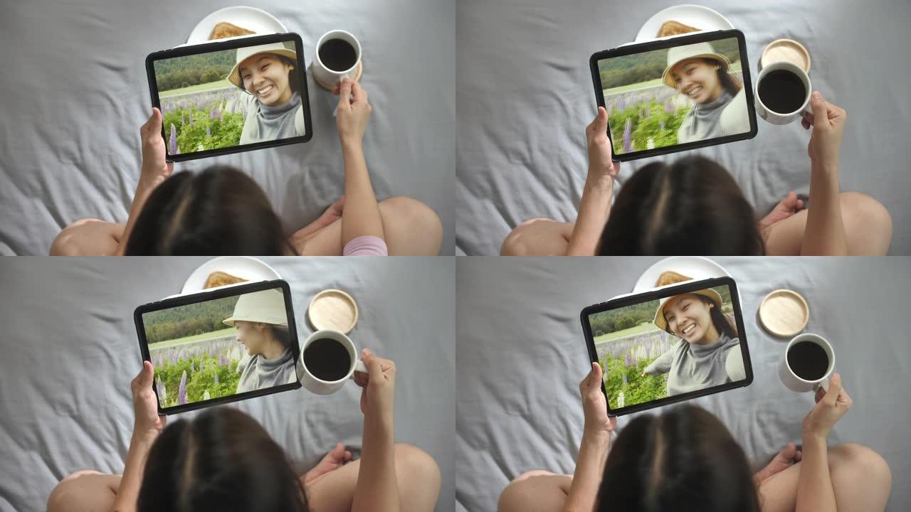 女人在数字平板电脑上与朋友进行视频通话