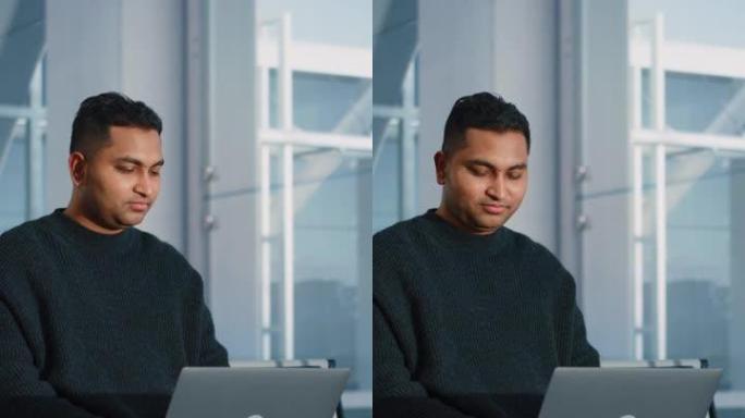 垂直屏幕。机场航站楼: 印度商人使用笔记本电脑，等待他的航班。坐在航空枢纽登机休息室的旅行数字企业家