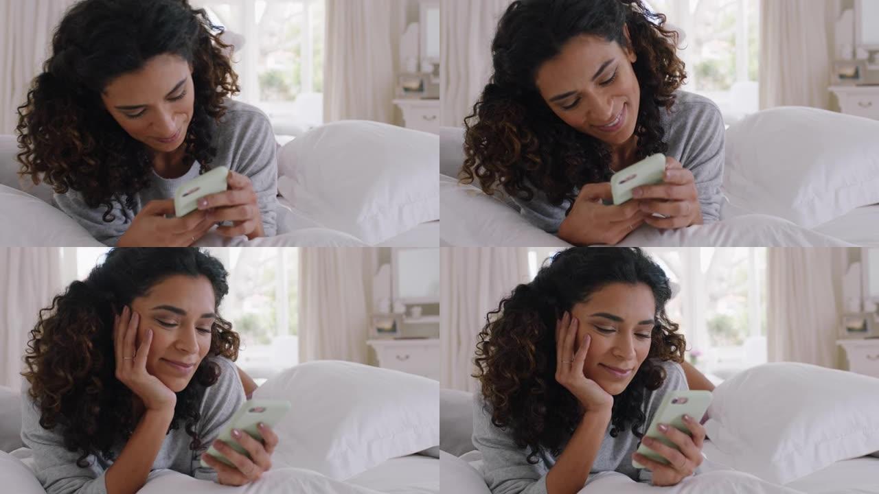 年轻美女使用智能手机短信浏览社交媒体信息享受手机通信躺在床上在家4k镜头