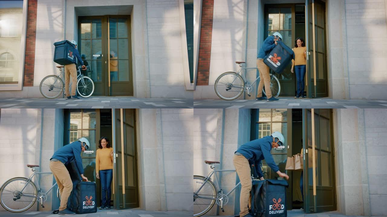 快乐的送餐男子在自行车上穿着保暖背包，向美丽的女性顾客提供餐厅订单。快递员在城市办公楼为华丽的女孩提
