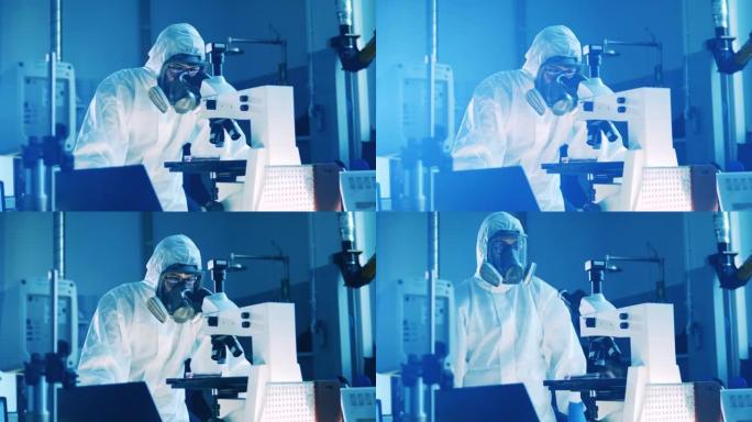 穿着防溅服的实验室工作人员正在操作显微镜